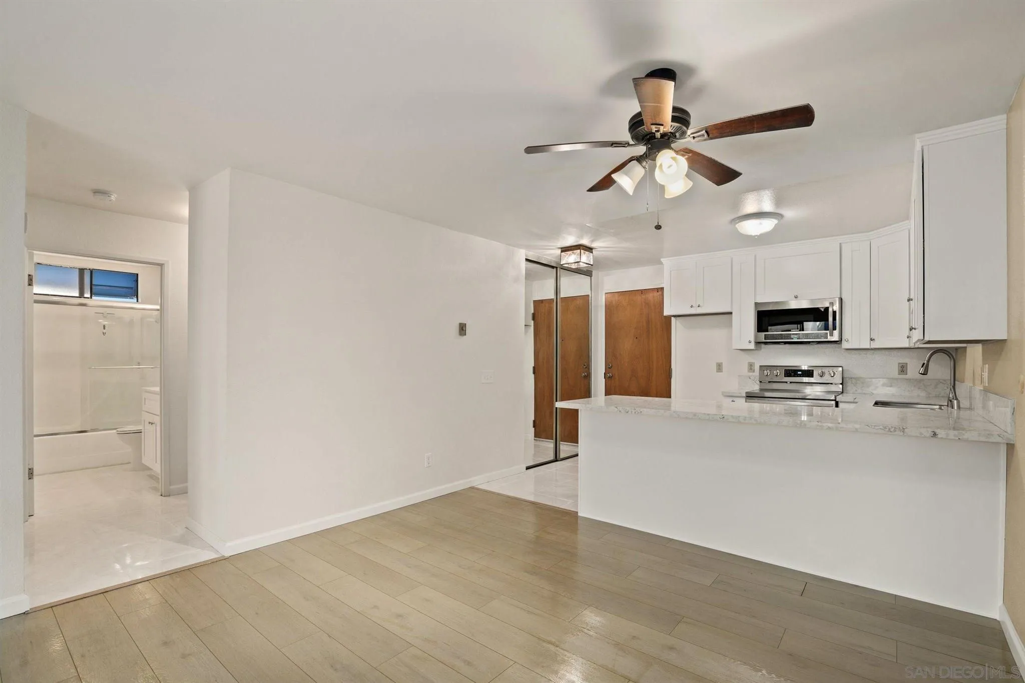 8308 Regents Road, Unit 1H San Diego, CA 92122 - Photo 3 of 14 a view of a kitchen with a sink and a refrigerator