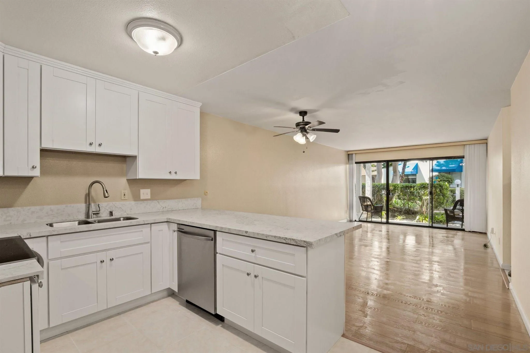 8308 Regents Road, Unit 1H San Diego, CA 92122 - Photo 5 of 14 a kitchen with a sink cabinets and window