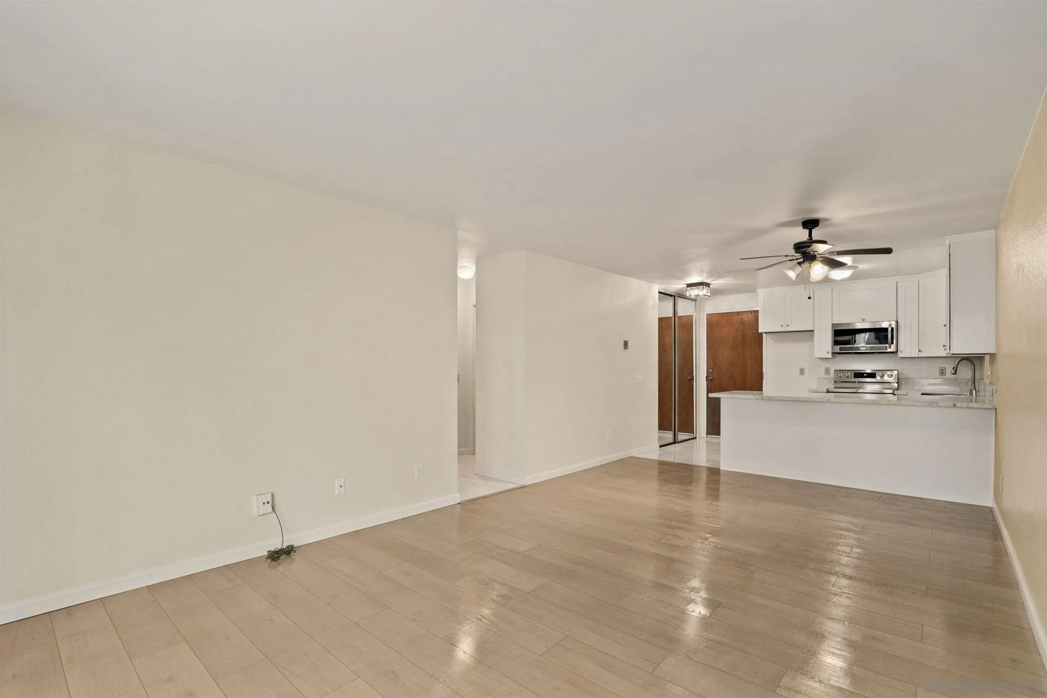 8308 Regents Road, Unit 1H San Diego, CA 92122 - Photo 9 of 14 a view of a kitchen with a sink and a chandelier