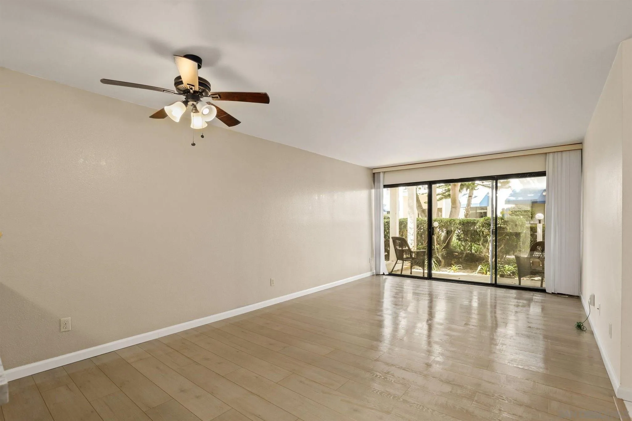 8308 Regents Road, Unit 1H San Diego, CA 92122 - Photo 10 of 14 wooden floor in an empty room with a window