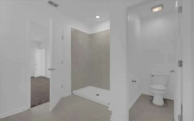 a bathroom with a toilet sink and shower