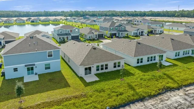 an aerial view of a house with a big yard