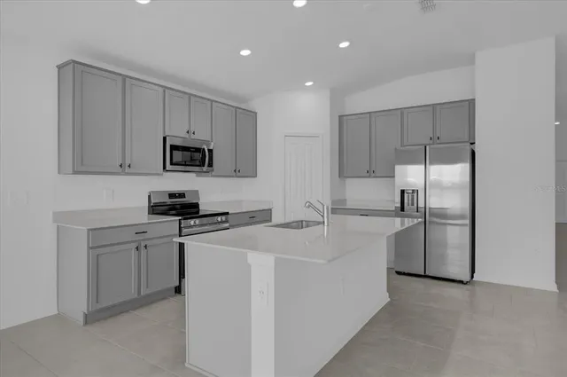 a kitchen with cabinets and stainless steel appliances