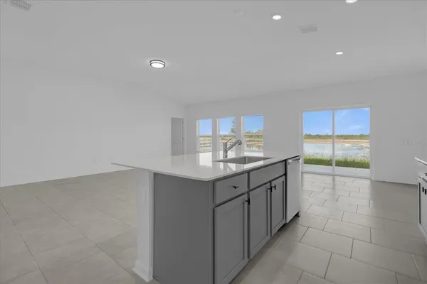 a bathroom with a granite countertop sink and washing machine