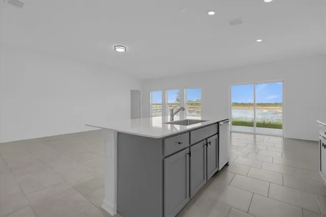 a bathroom with a granite countertop sink and washing machine