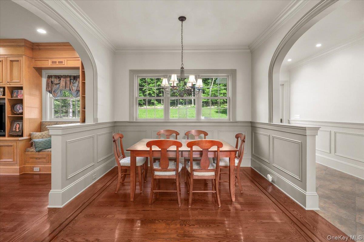 135 Pines Bridge Road Katonah, NY 10536 - Photo 11 of 40 a dining room with furniture a chandelier and wooden floor
