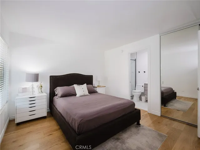 a bedroom with a bed and a closet