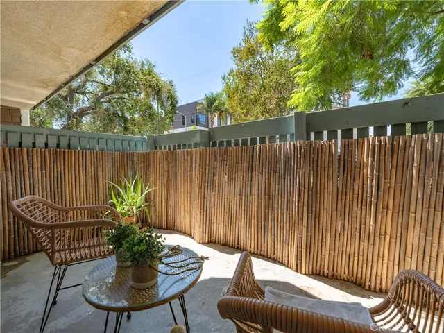 a balcony with table and chairs