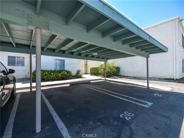 a view of a patio with table and chairs under an umbrella