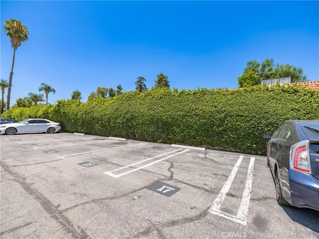 a view of a parking area with potted plants