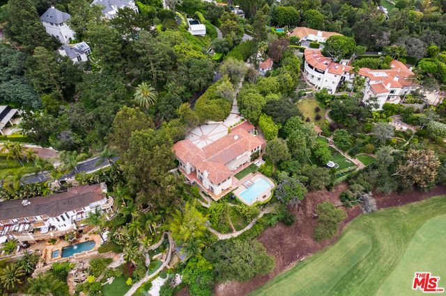 an aerial view of a house with a yard