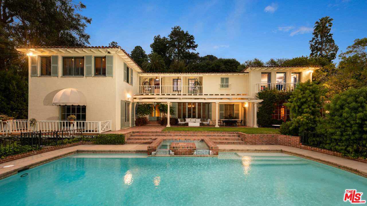 10800 Chalon Road Los Angeles, CA 90077 - Photo 3 of 14 a front view of a house with swimming pool having outdoor seating