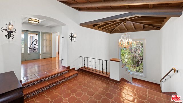 a view of a livingroom with furniture and staircase