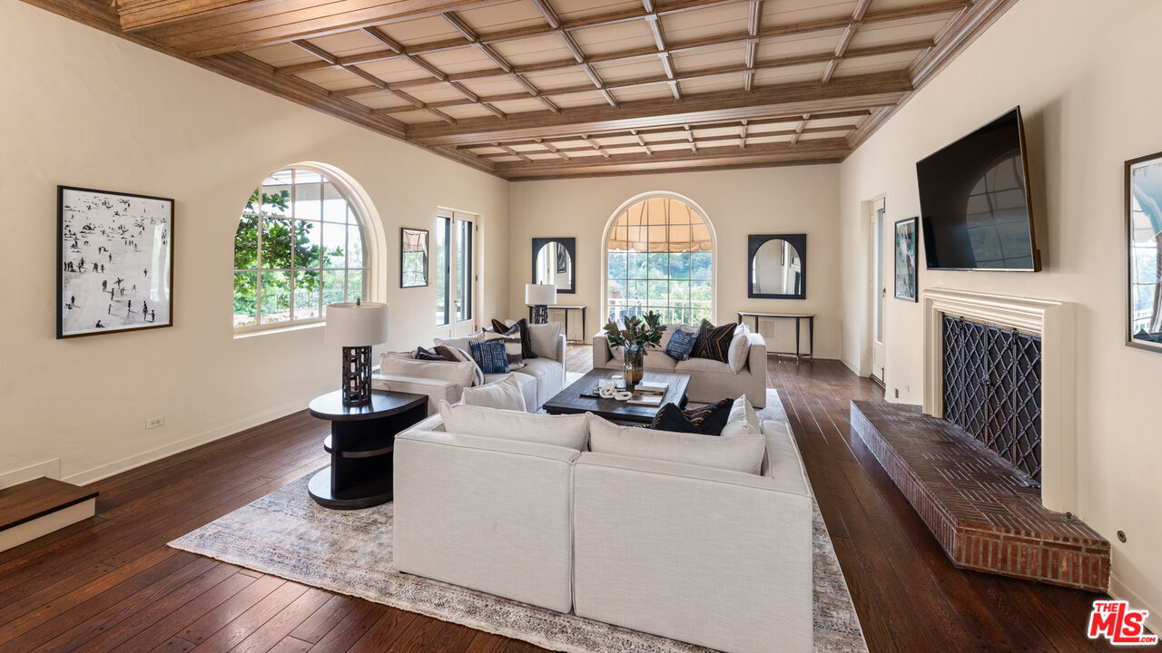10800 Chalon Road Los Angeles, CA 90077 - Photo 5 of 14 a living room with furniture fireplace and flat screen tv