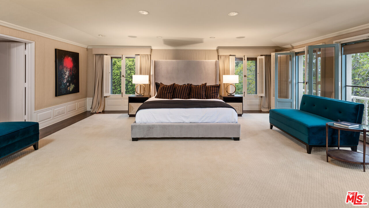 10800 Chalon Road Los Angeles, CA 90077 - Photo 7 of 14 a spacious bedroom with a bed a couch and a window