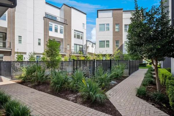 a front view of a residential apartment building with a yard