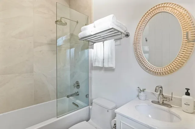 a kitchen with kitchen island a sink appliances and a window