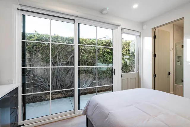 a bathroom with a sink a mirror a toilet and a shower