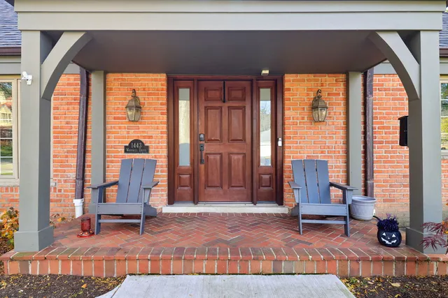 a living room with furniture and large windows