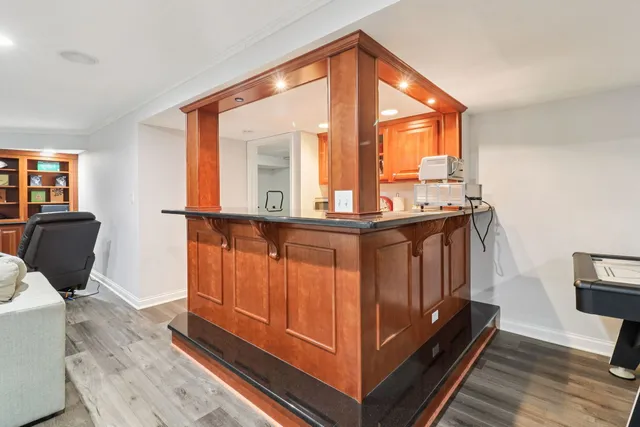 a living room with furniture a flat screen tv and a wooden floor