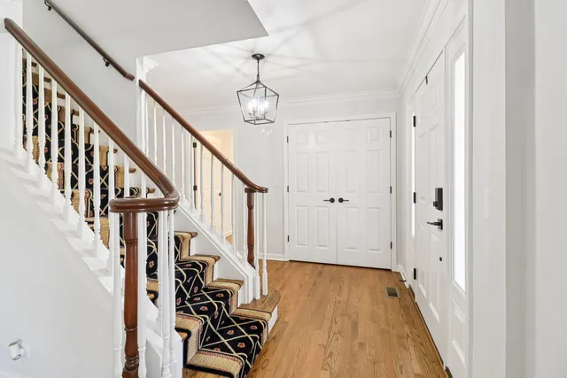 a view of entryway with wooden floor and stairs