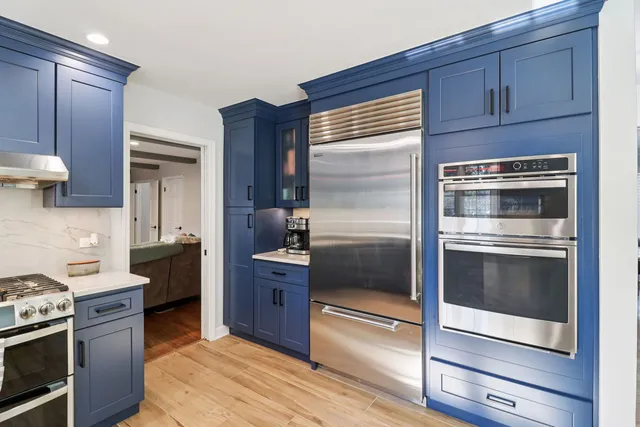 a kitchen with granite countertop stainless steel appliances and wooden cabinets