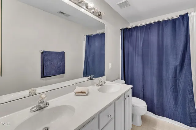 a living room with furniture a flat screen tv and a window