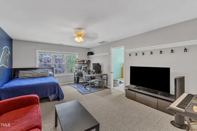 a bedroom with furniture and a flat screen tv