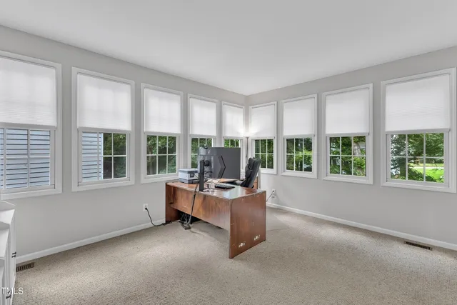 a living room with furniture and large windows