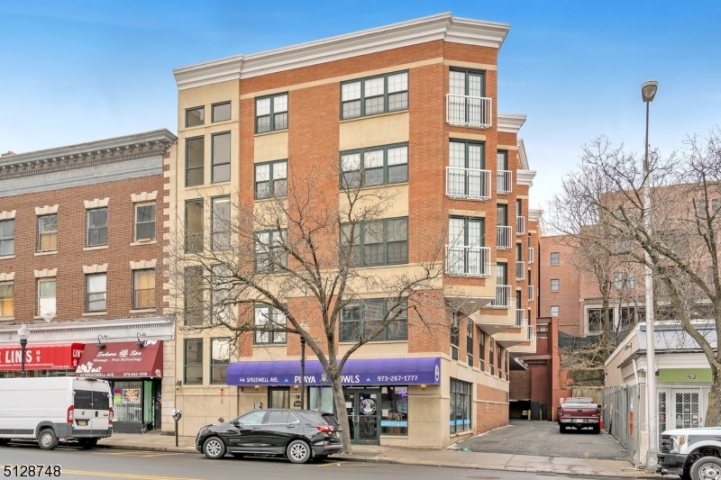 7 Prospect Street, Unit 303 Morristown, NJ 07960 - Photo 1 of 22 a front view of a building with lot of cars and trees