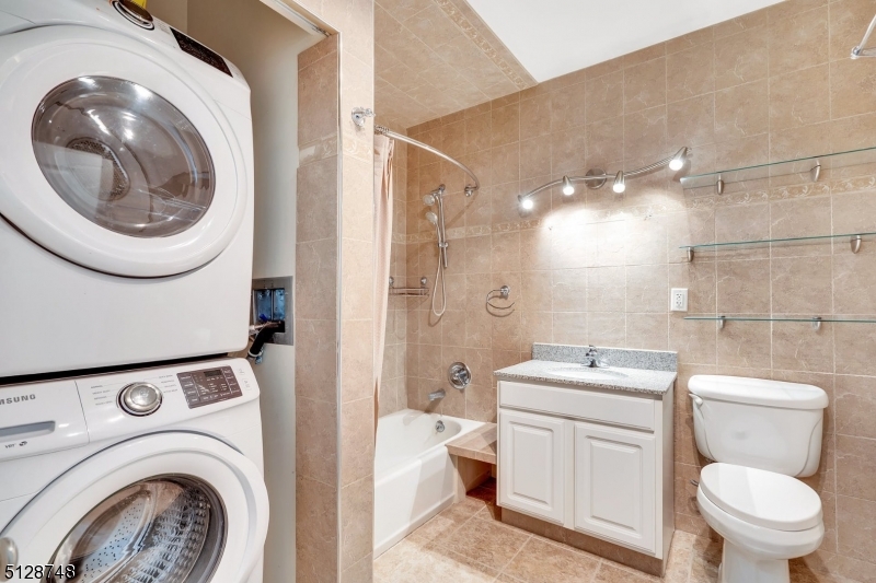 7 Prospect Street, Unit 303 Morristown, NJ 07960 - Photo 20 of 22 a bathroom with a toilet a sink and a mirror