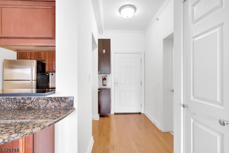 7 Prospect Street, Unit 303 Morristown, NJ 07960 - Photo 9 of 22 a bathroom with a granite countertop sink and a mirror