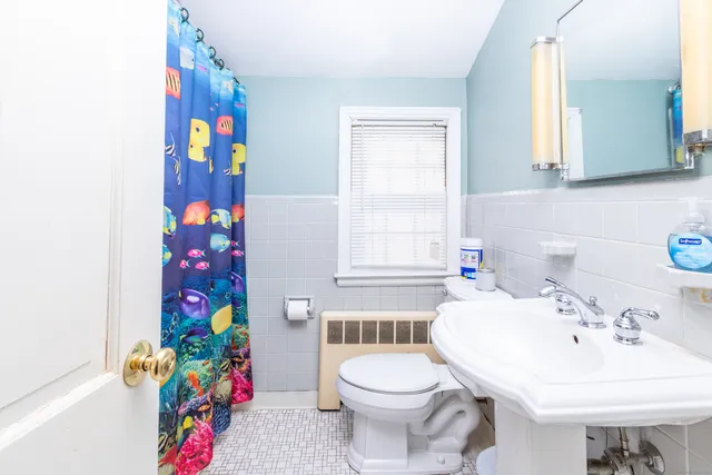 a bathroom with a sink a toilet and a mirror