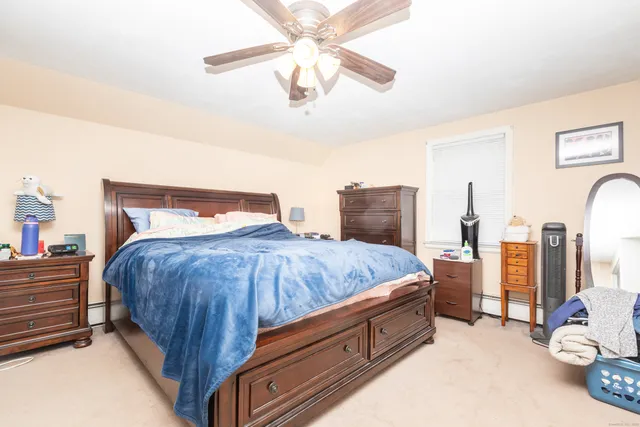 a spacious bedroom with a bed and a chandelier
