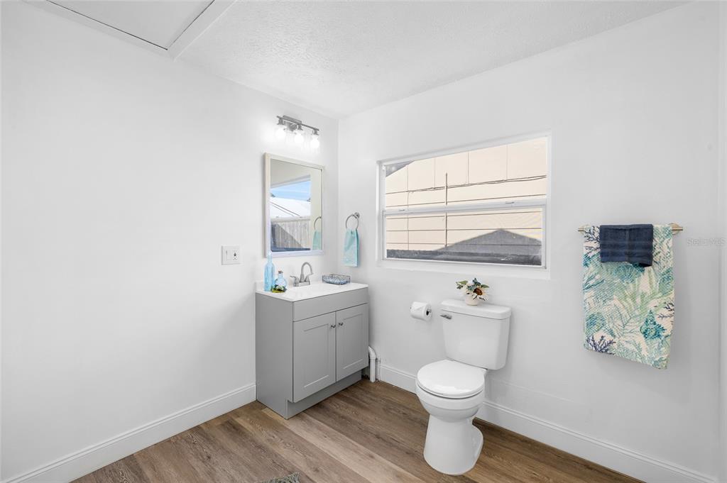 4244 Mesa Drive New Port Richey, FL 34653 - Photo 17 of 35 a bathroom with a toilet a sink and a window