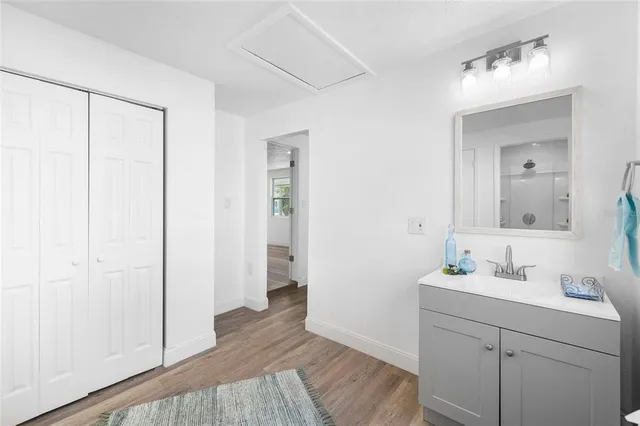 a bathroom with a sink a mirror and shower