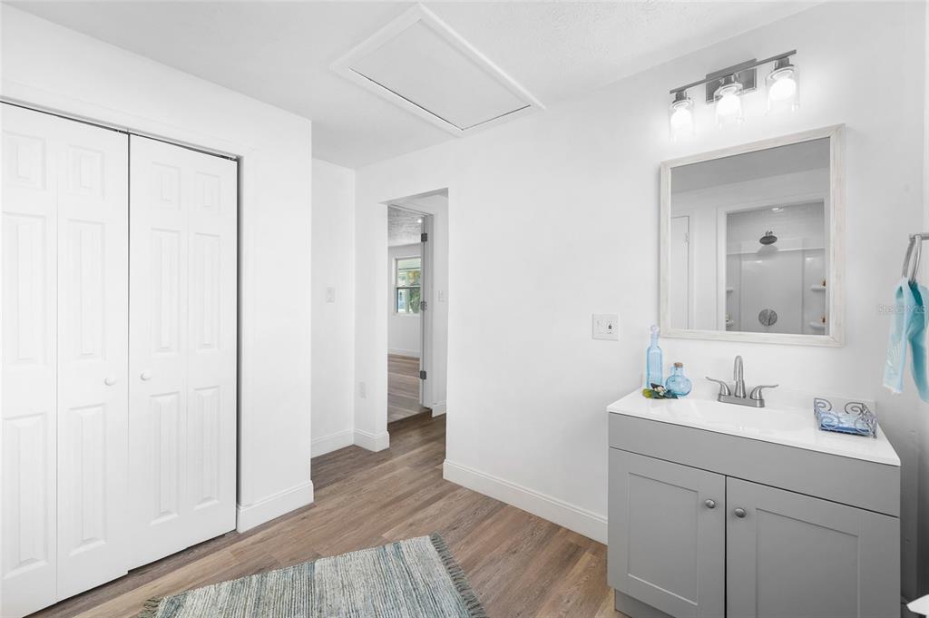4244 Mesa Drive New Port Richey, FL 34653 - Photo 18 of 35 a bathroom with a sink a mirror and shower