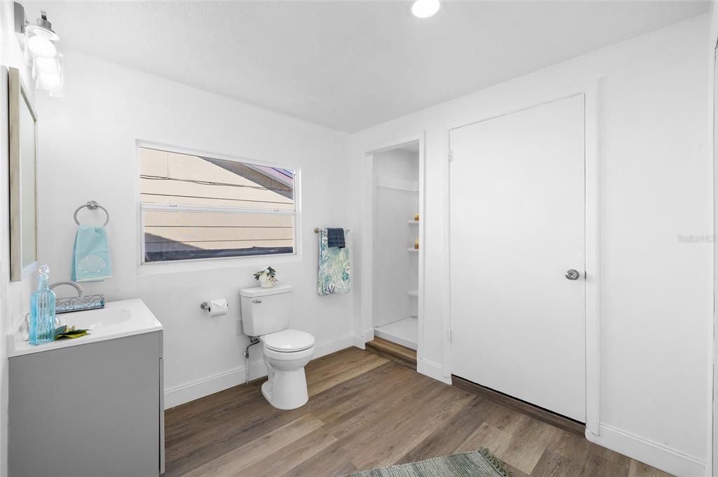 4244 Mesa Drive New Port Richey, FL 34653 - Photo 19 of 35 a bathroom with a toilet sink and mirror