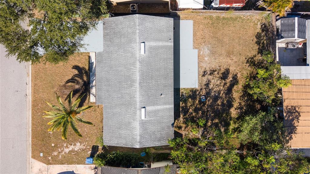 4244 Mesa Drive New Port Richey, FL 34653 - Photo 33 of 35 an aerial view of a house with a yard and large trees