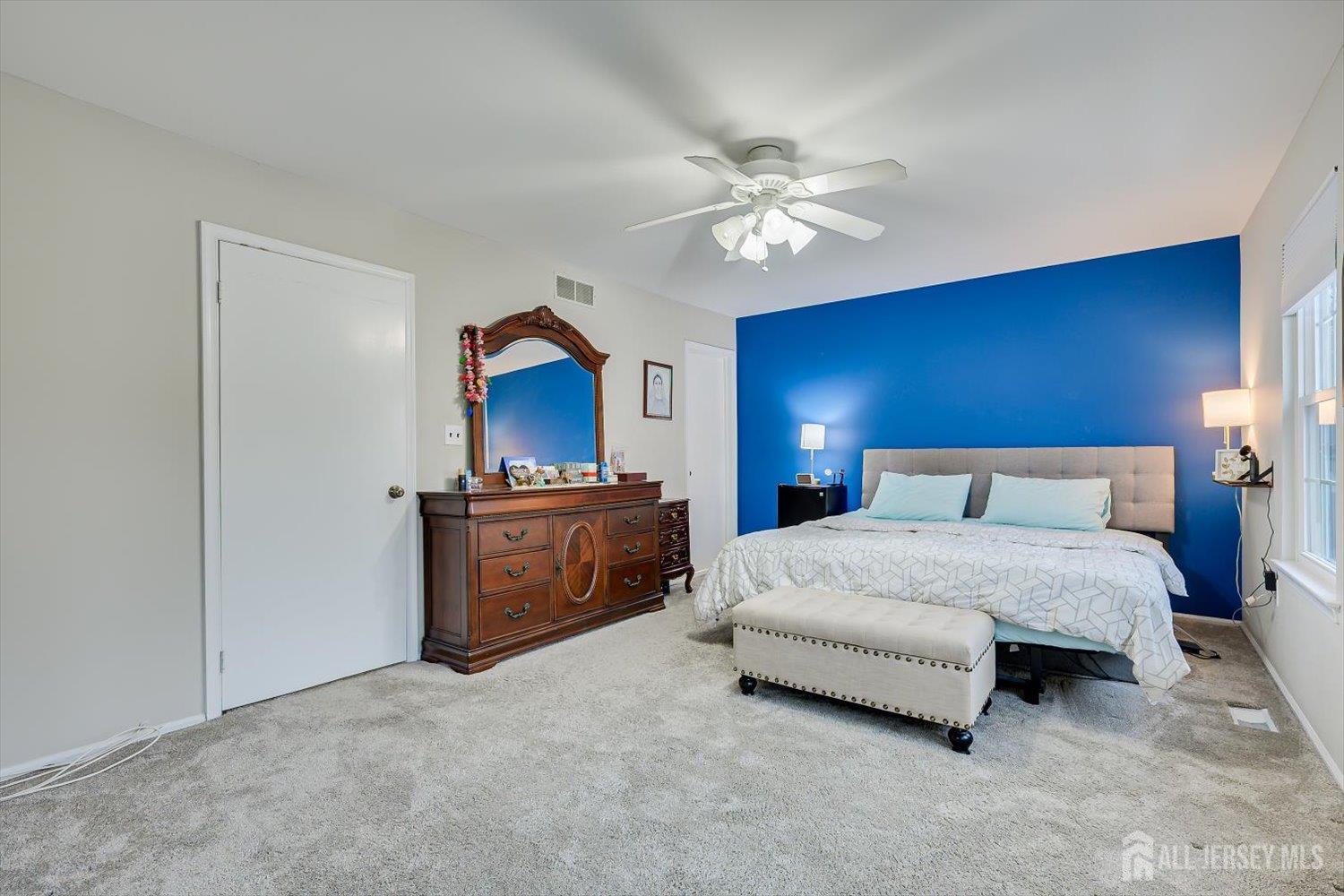 199 Applegate Lane East Brunswick, NJ 08816 - Photo 21 of 38 a spacious bedroom with a bed and a chandelier