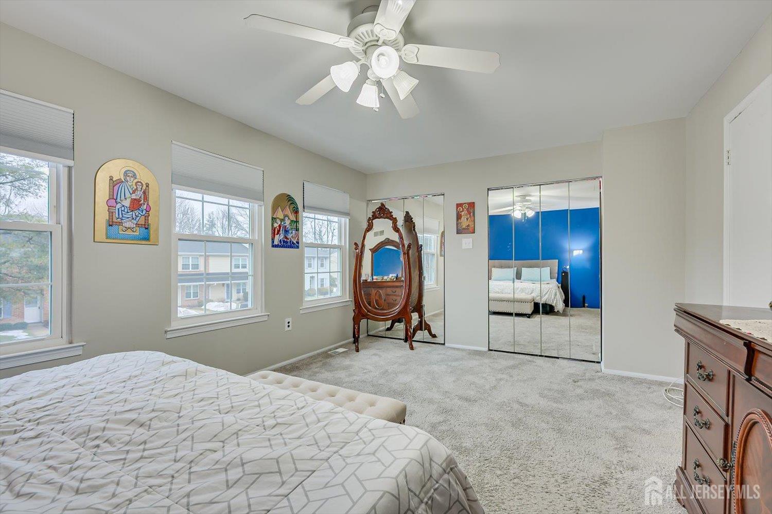 199 Applegate Lane East Brunswick, NJ 08816 - Photo 22 of 38 a bedroom with a bed and a chandelier