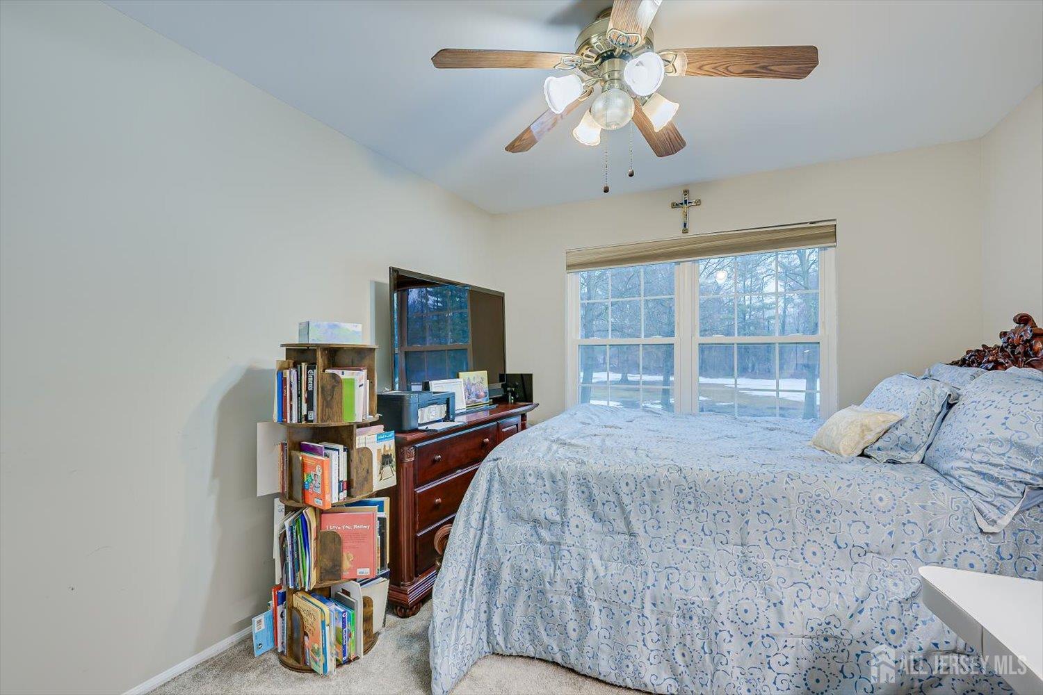 199 Applegate Lane East Brunswick, NJ 08816 - Photo 25 of 38 a bedroom with a bed bookshelf and a window