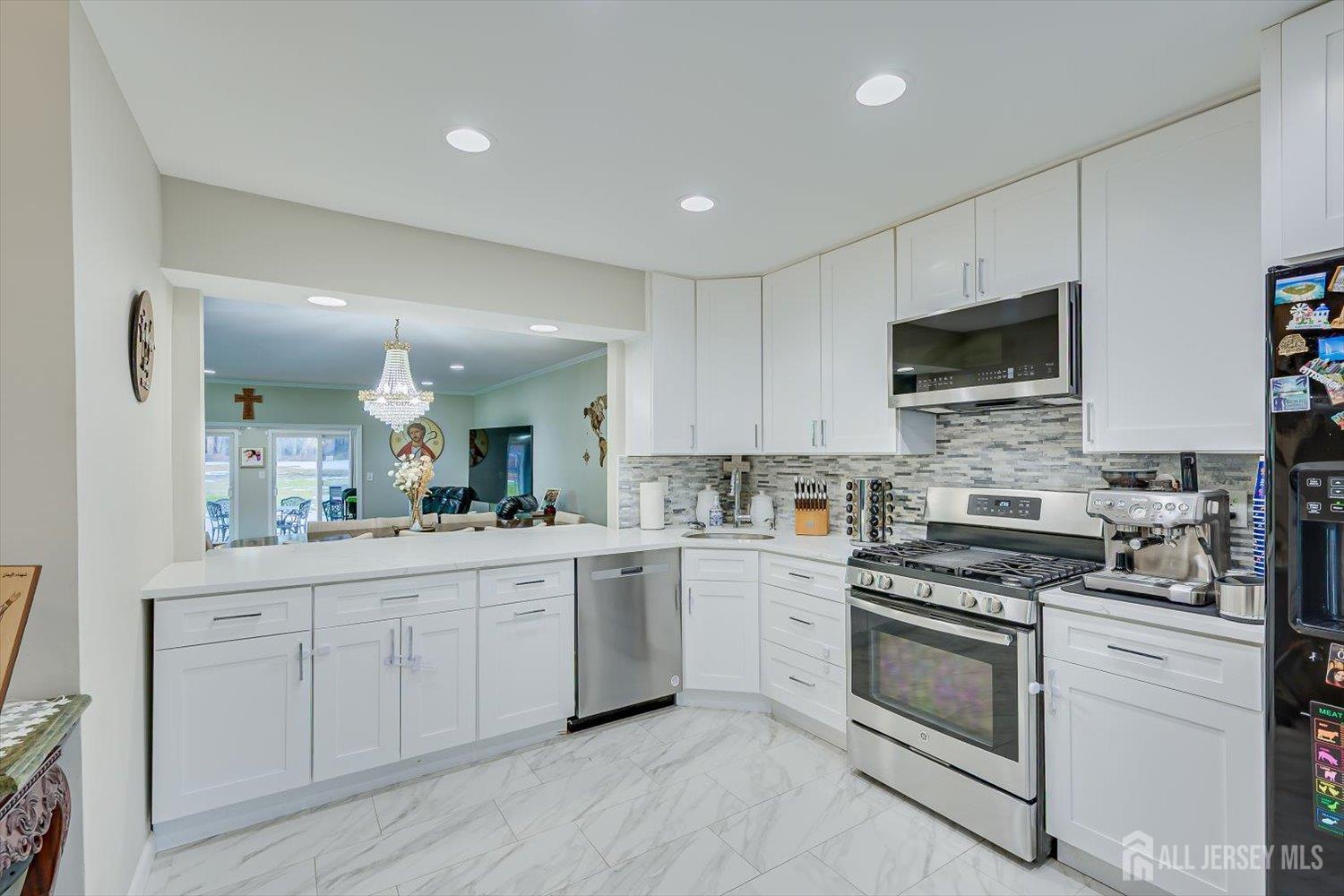 199 Applegate Lane East Brunswick, NJ 08816 - Photo 3 of 38 a kitchen with white cabinets stainless steel appliances and sink