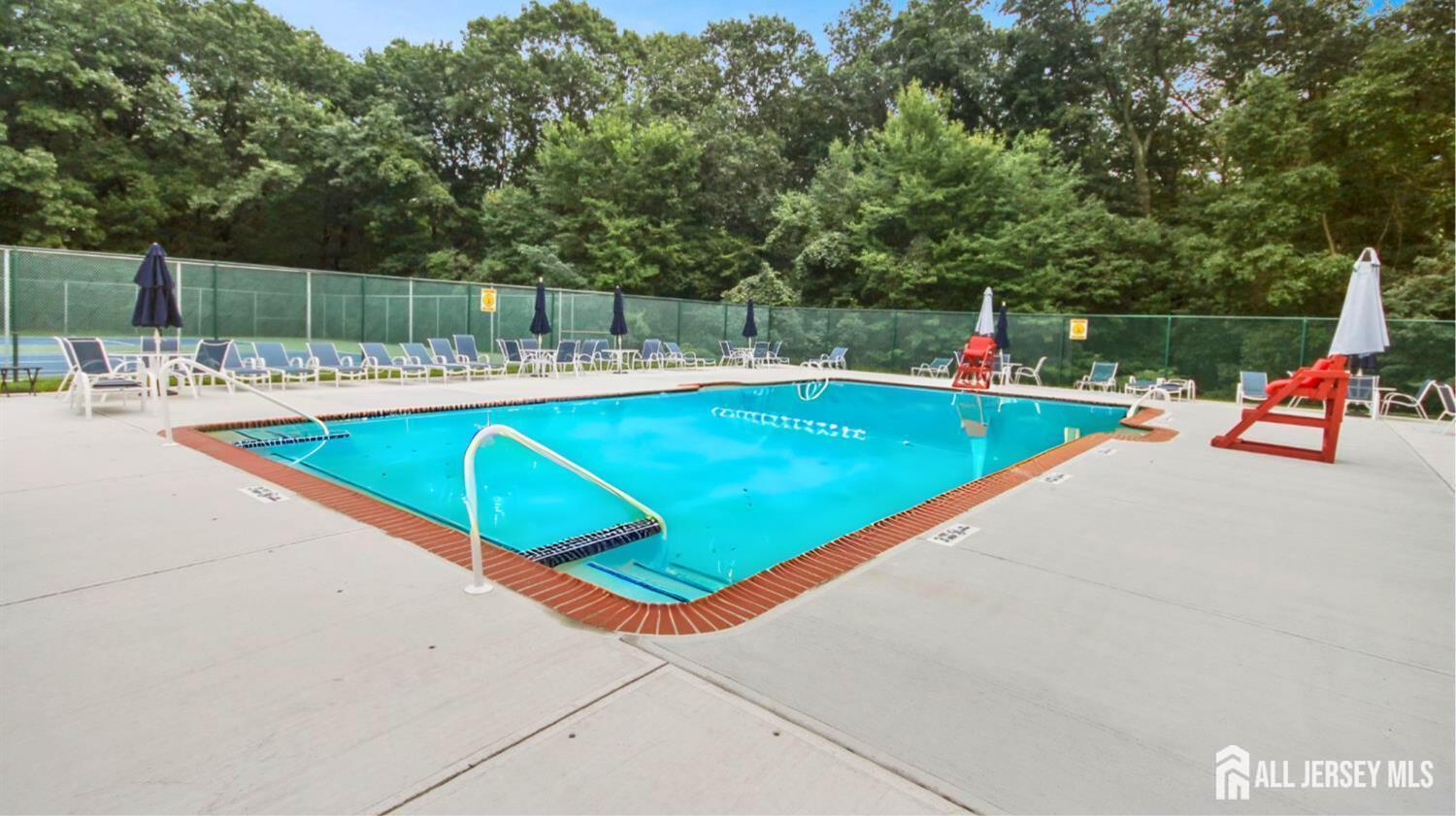 199 Applegate Lane East Brunswick, NJ 08816 - Photo 36 of 38 a view of a swimming pool with a lounge chairs