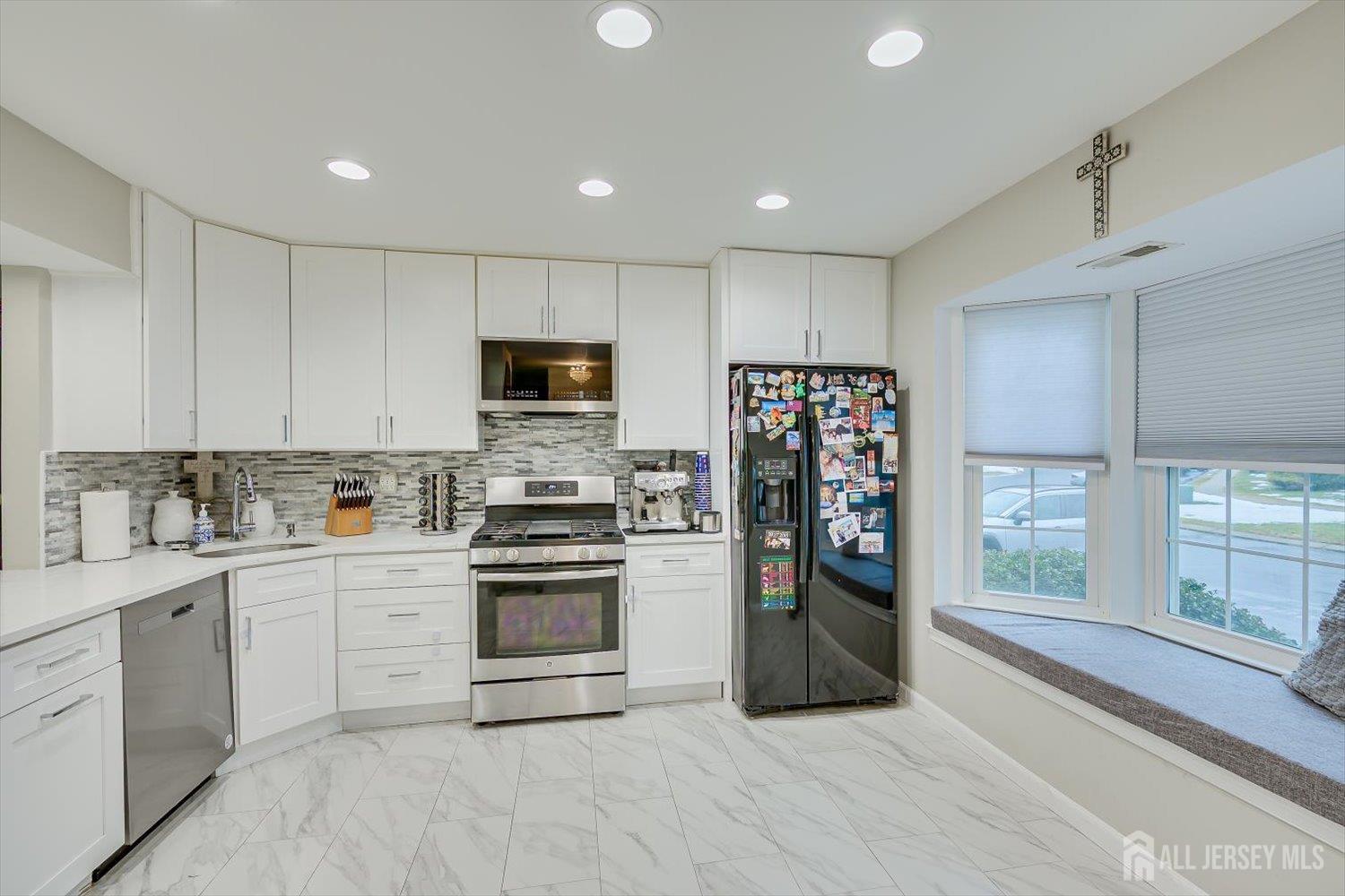 199 Applegate Lane East Brunswick, NJ 08816 - Photo 5 of 38 a kitchen with stainless steel appliances granite countertop a refrigerator and a stove top oven