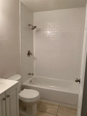 a bathroom with a shower and a toilet