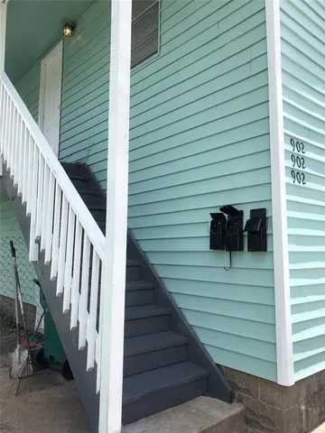 a view of a house with a door and stairs