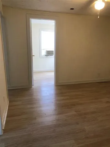 a view of a room with wooden floor