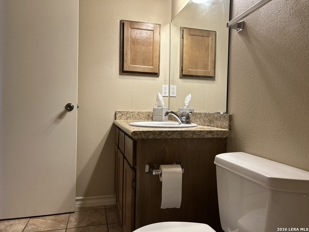 13018 Heimer Road, Unit 710 San Antonio, TX 78216 - Photo 19 of 27 a bathroom with a sink a toilet and mirror