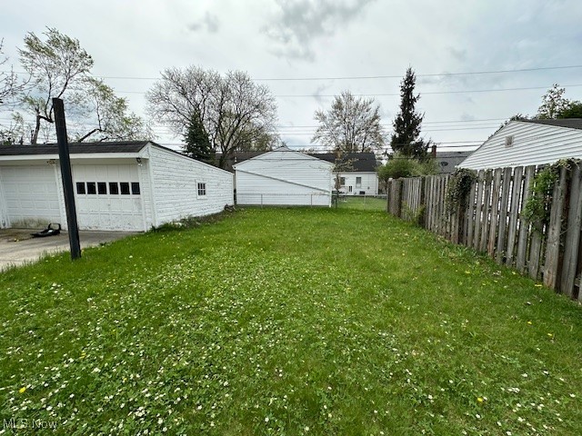 3832 Wallingford Road South Euclid, OH 44121 - Photo 5 of 16 View of yard featuring a detached garage, fence, and an outbuilding